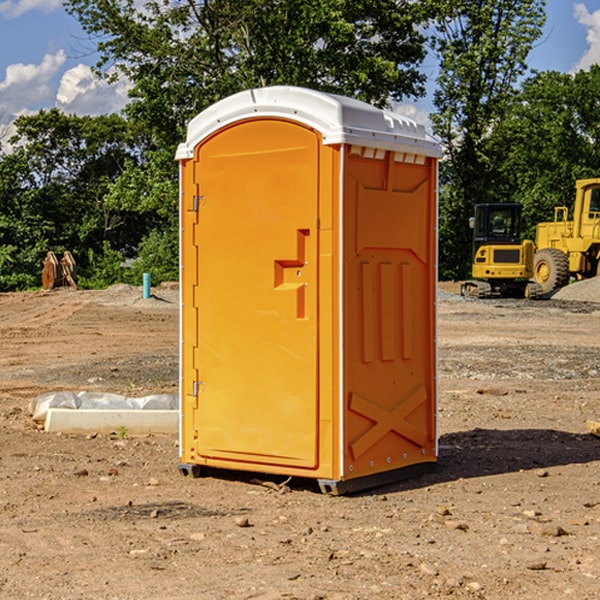 what is the cost difference between standard and deluxe portable restroom rentals in Brooklyn Center